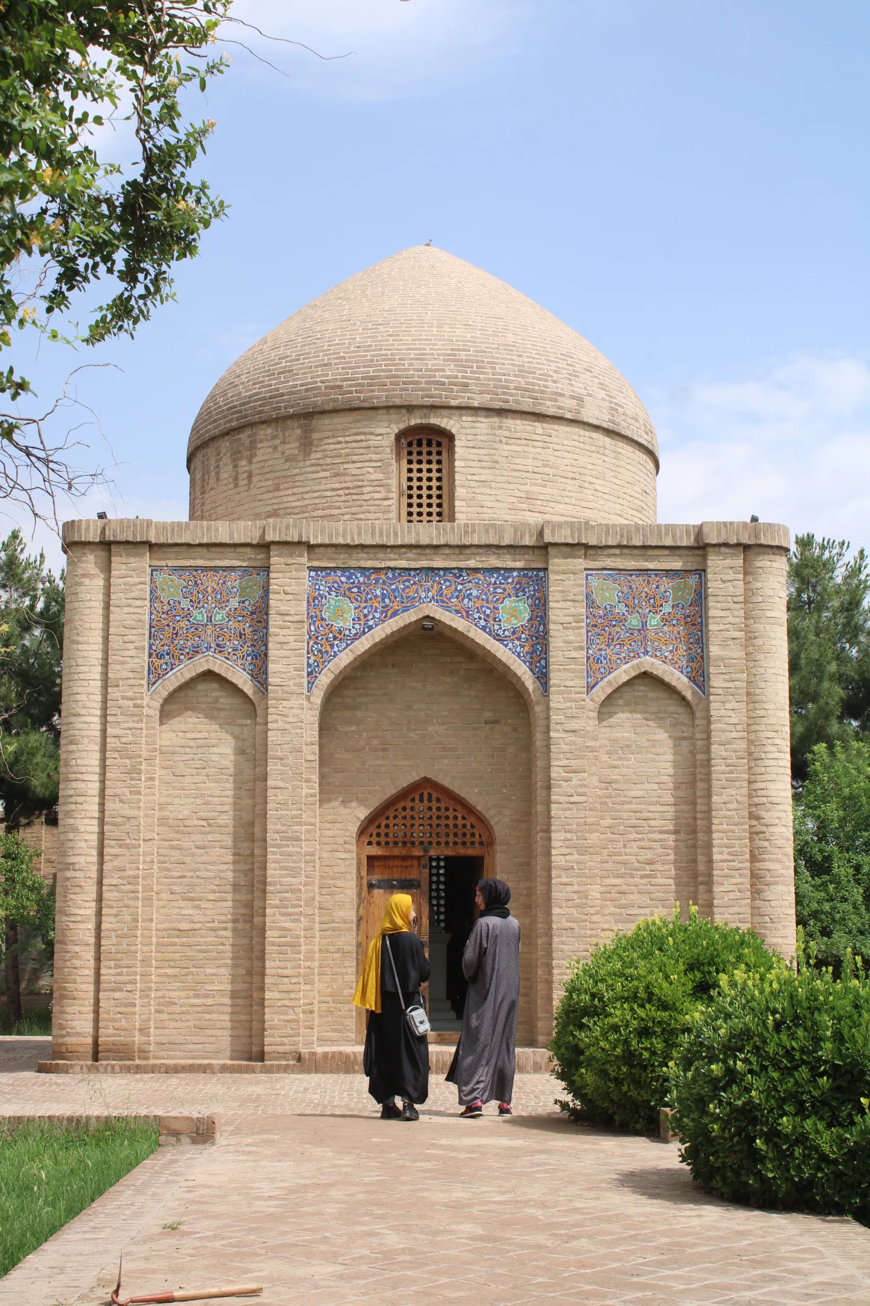 Next to the shrine of Amir Ali Sher Nawai in Herat — a meaningful moment as our local female tour guide shares stories and history with the traveler during their journey
